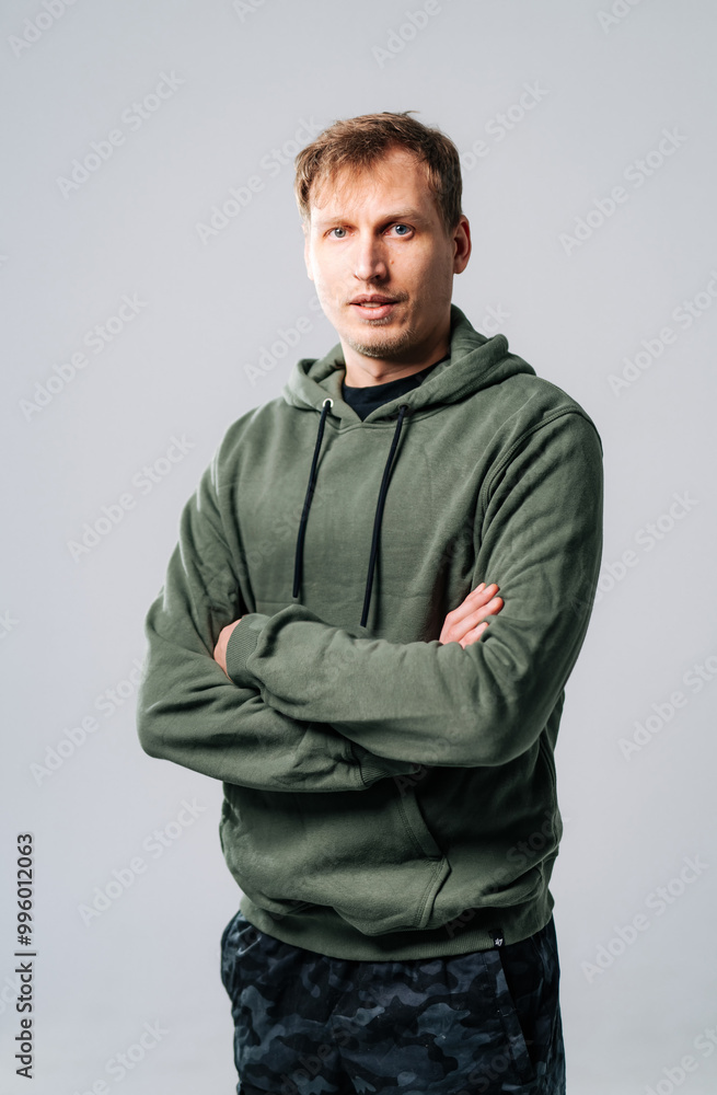 Young man with arms crossed in casual wear. Young man with arms crossed in casual wear.