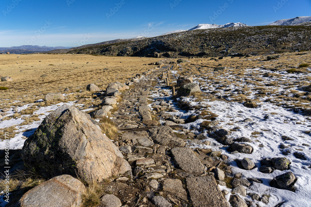 Main path that goes up to the big lake of Gredos Natural park in a sunny winter day. Ávila, Castilla y León, Spain. Main path that goes up to the big lake of Gredos Natural park in a sunny winter day. Ávila, Castilla y León, Spain.