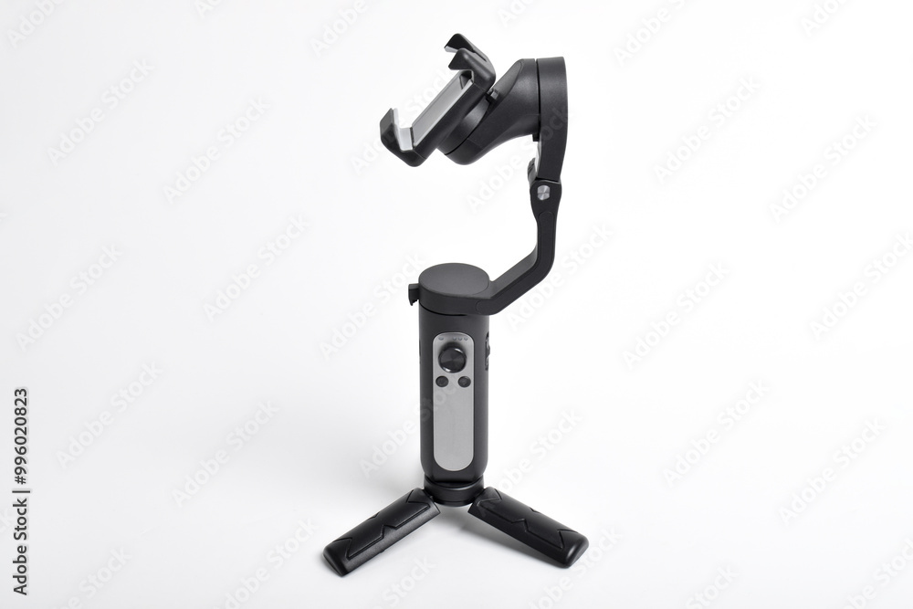 Gimbal stabilizer for Smartphone isolated on white background. Modern stabilizer-gimbal for photo-video shooting. Gadgets for blogging, streaming, video and videography Gimbal stabilizer for Smartphone isolated on white background. Modern stabilizer-gimbal for photo-video shooting. Gadgets for blogging, streaming, video and videography