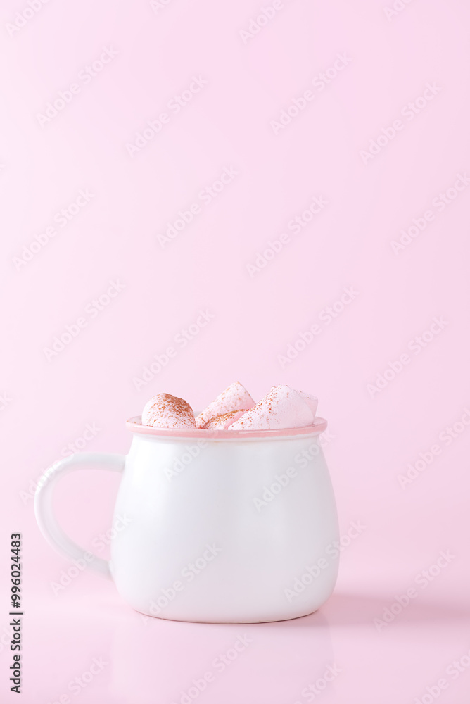Cocoa drink with marshmallows on a pink background. Vegan, sugar and lactose free. Vertical orientation. Cocoa drink with marshmallows on a pink background. Vegan, sugar and lactose free. Vertical orientation.