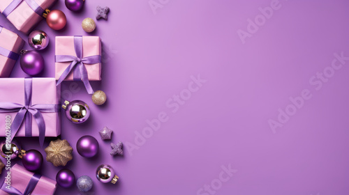 Top view of gifts, bows and Christmas decorations on a purple background