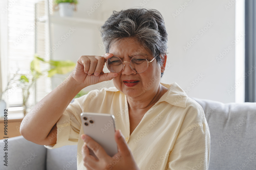 Elderly woman have eyesight problem can not read because seeing text blurred and headache from eye tired. Elderly woman have eyesight problem can not read because seeing text blurred and headache from eye tired.