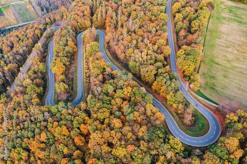 Aerial view of a winding road through the autumn forests of the Taunus