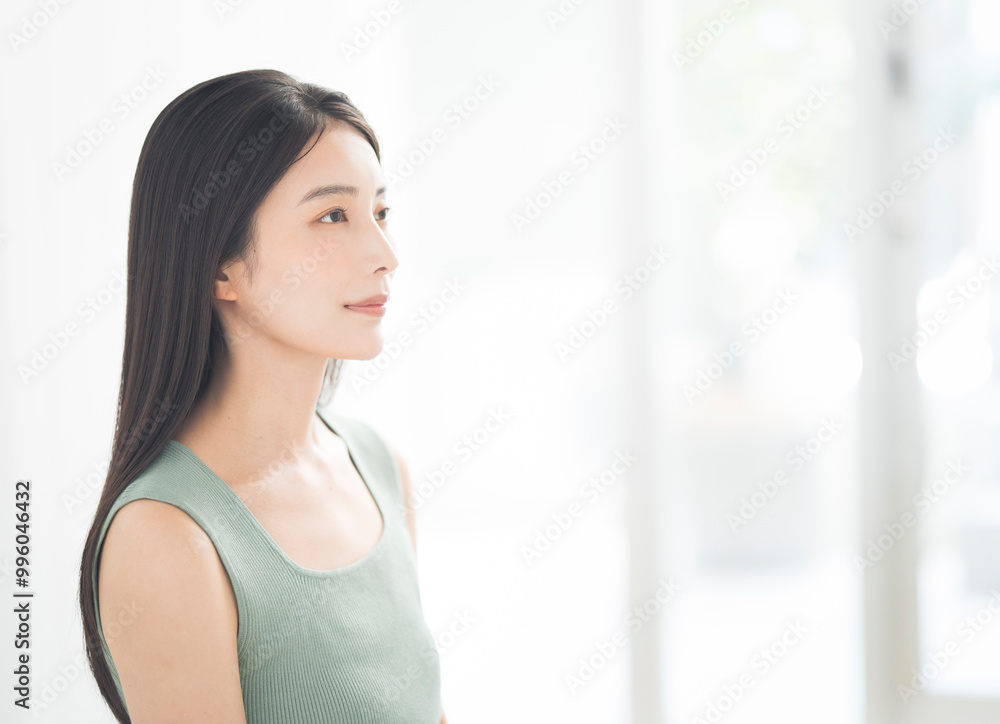 Portrait of a young beautiful Asian woman. She has straight black hair. Portrait of a young beautiful Asian woman. She has straight black hair.