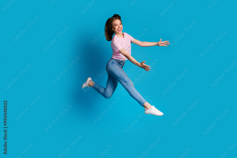 Photo of positive lovely cute woman wear trendy pink clothes hold object empty space isolated on blue color background Photo of positive lovely cute woman wear trendy pink clothes hold object empty space isolated on blue color background