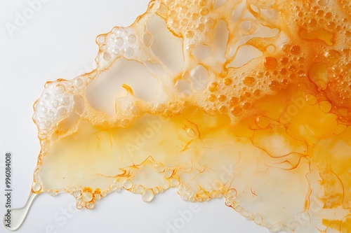 Spilled orange slurry bubbles on white, revealing mesmerizing colors. Macro view shows science of fresh citrus juice. Enjoy sweet, sour, vitamin packed drink