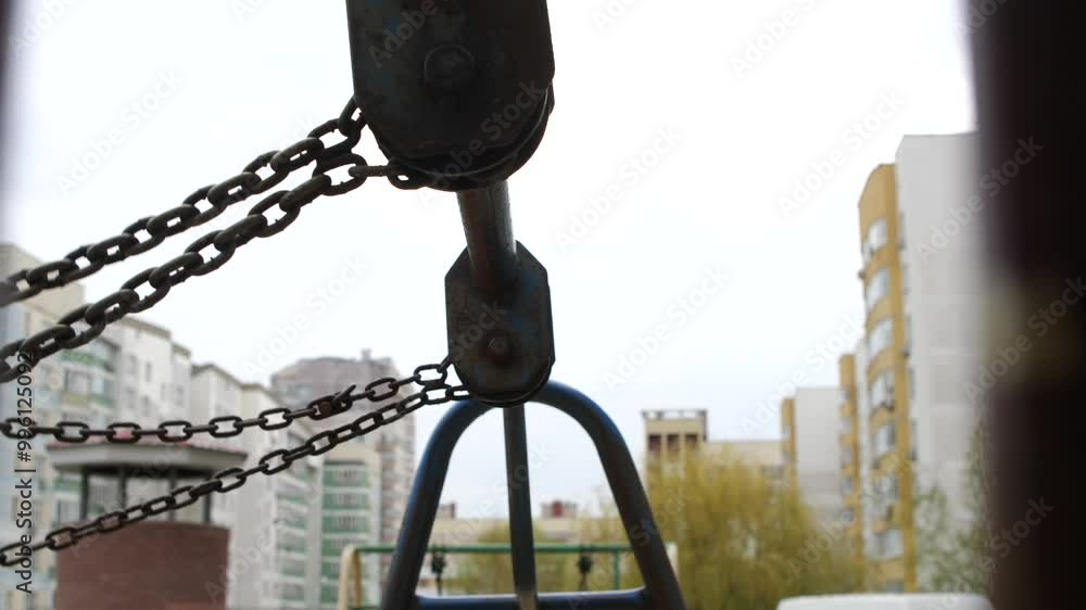 Swing in the playground. Swinging. Close up on chain. Swing in the playground. Swinging. Close up on chain.