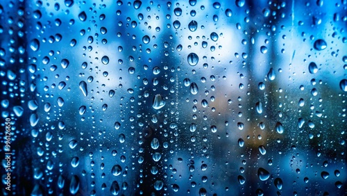 Water droplets are forming on a glass surface creating an abstract pattern