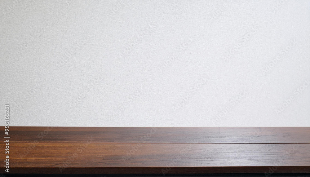 Wooden tabletop with a white wall, offering a clean and simple backdrop for product display. Wooden tabletop with a white wall, offering a clean and simple backdrop for product display.
