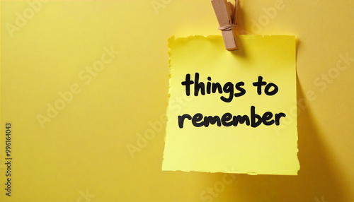 Yellow sticky note hanging on the wall saying things to remember