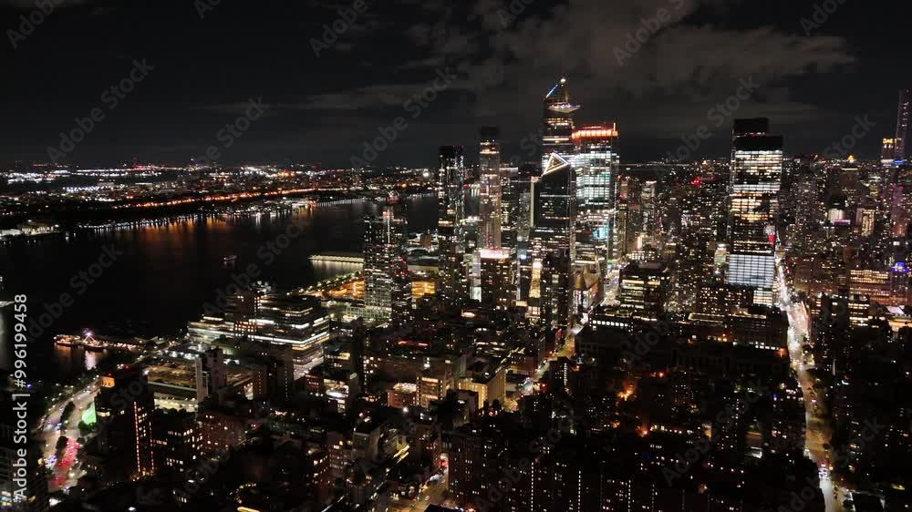 Flight above the New York City Manhattan panoramic view at dusk from the Hudson River. The view of the skyscrapers of Midtown West Hudson Yards redevelopment project . NYC, NY, USA Flight above the New York City Manhattan panoramic view at dusk from the Hudson River. The view of the skyscrapers of Midtown West Hudson Yards redevelopment project . NYC, NY, USA