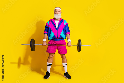 Full size photo poster of handsome granddad sportsman lift barbell wear trendy vintage sportswear isolated on yellow color background