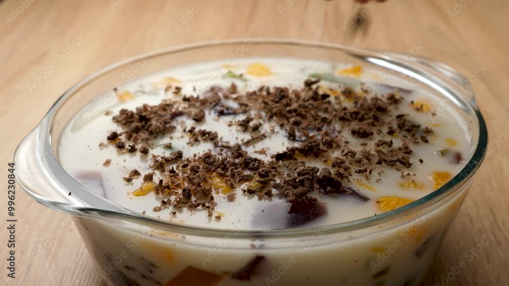 Chocolate shavings are added to the hardened dessert jelly. Preparation of gelatin desserts. Slow motion Chocolate shavings are added to the hardened dessert jelly. Preparation of gelatin desserts. Slow motion