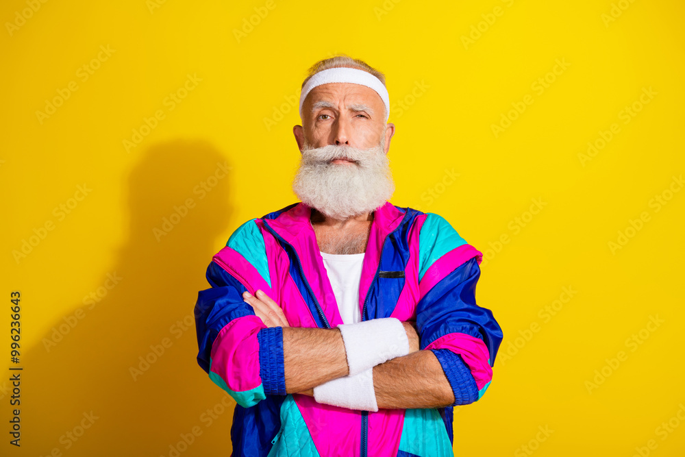 Photo of attractive confident retired sportsman retro sportswear arms crossed emtpy space isolated yellow color background Photo of attractive confident retired sportsman retro sportswear arms crossed emtpy space isolated yellow color background