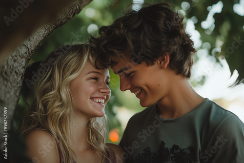 A young man and woman are hugging and smiling at each other