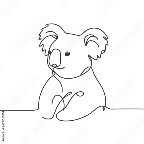 A koala bear is sitting on a table. The bear is looking at the camera and he is smiling