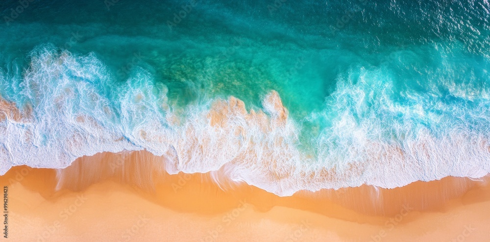 Waves on the beach as a background. Natural backdrop for summer vacation holidays. View from above showing the beach and sea with blue water waves Waves on the beach as a background. Natural backdrop for summer vacation holidays. View from above showing the beach and sea with blue water waves