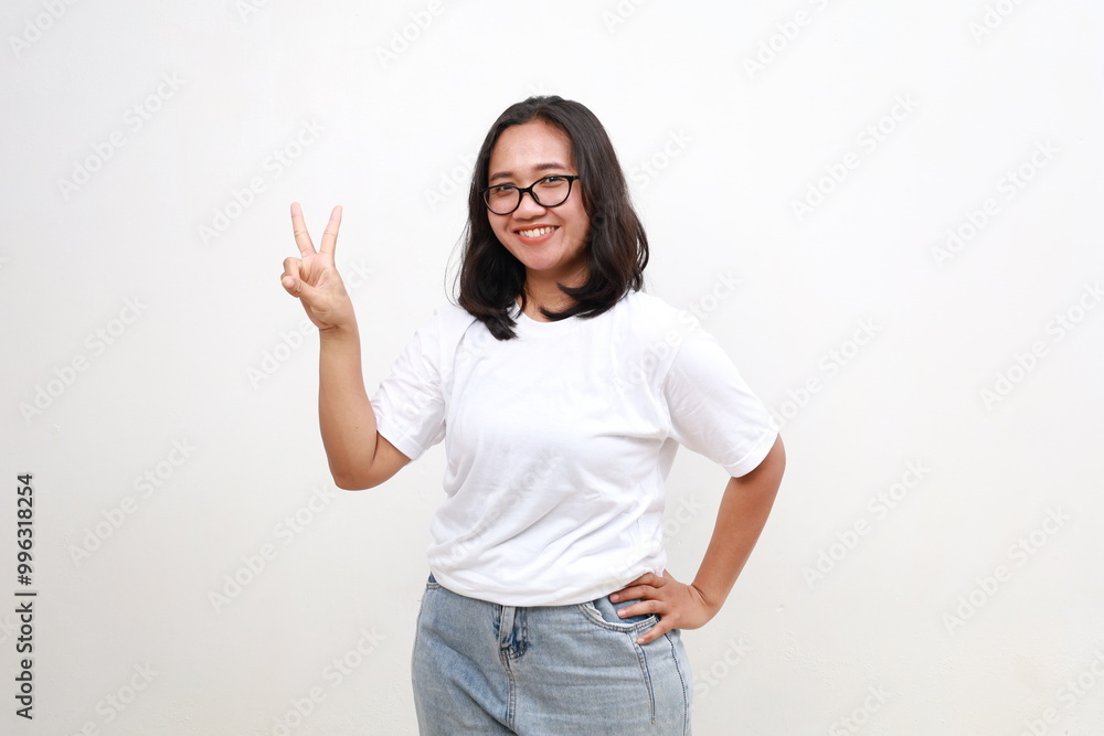 Smiling happy good-looking asian girl giving advice, showing two fingers as explain rules, make point, standing white background Smiling happy good-looking asian girl giving advice, showing two fingers as explain rules, make point, standing white background