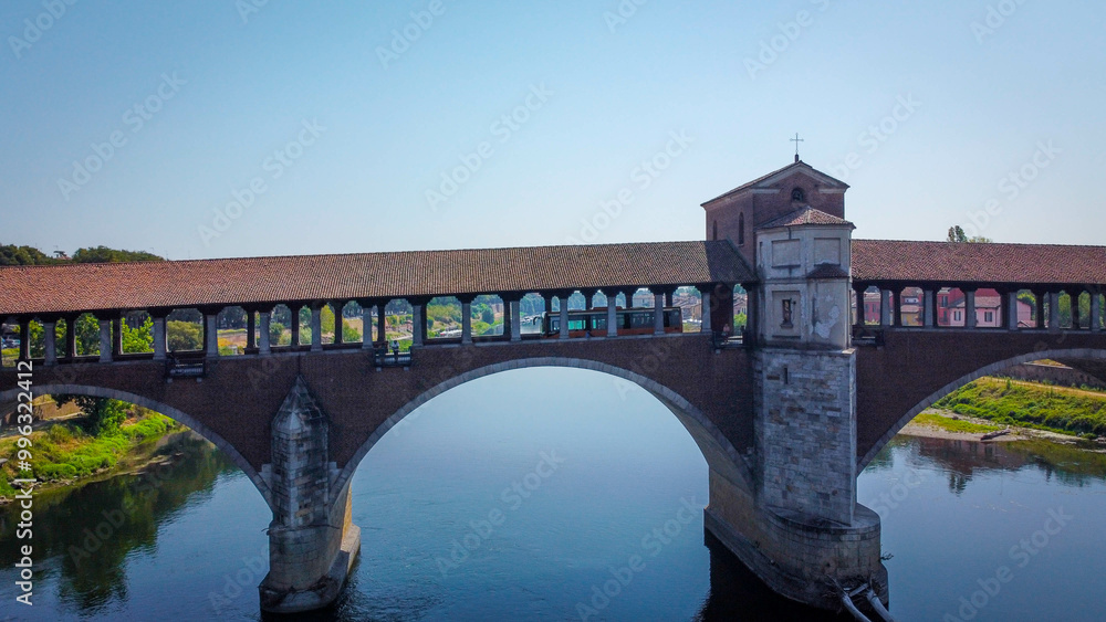 View of Ponte coperto (covered bridge) of Pavia, Italy. Bridge over the Ticino river in the city of Pavia in Lombardy. View of Ponte coperto (covered bridge) of Pavia, Italy. Bridge over the Ticino river in the city of Pavia in Lombardy.