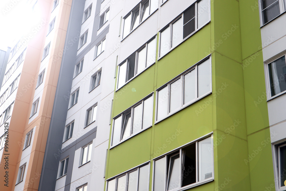 Modern high-rise buildings close-up windows of the house. Multi-storey residential building Modern high-rise buildings close-up windows of the house. Multi-storey residential building