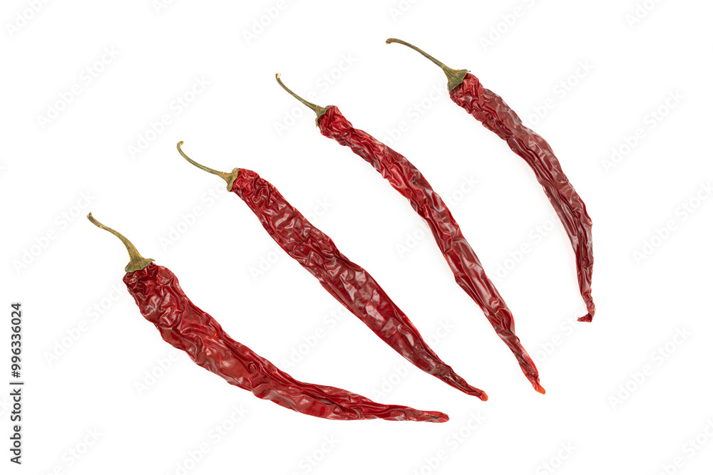 Four dried chili peppers on white background Four dried chili peppers on white background