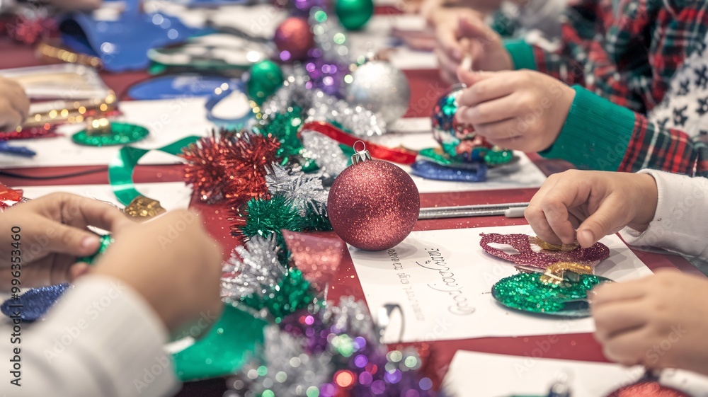 A heartwarming scene of children's hands busily crafting Christmas decorations, surrounded by glitter, ribbons, and colorful ornaments. A heartwarming scene of children's hands busily crafting Christmas decorations, surrounded by glitter, ribbons, and colorful ornaments.