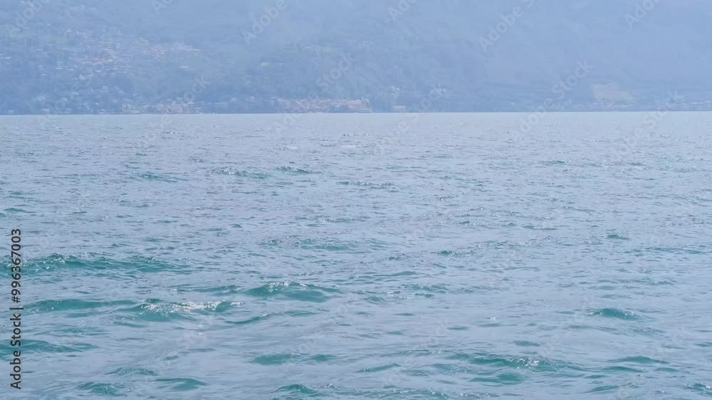 picturesque seascape, Lake Como in Italy, mountains in background, lonely boat bobbing on waves, maritime travel picturesque seascape, Lake Como in Italy, mountains in background, lonely boat bobbing on waves, maritime travel