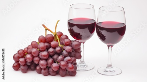 Fresh red grapes paired with glasses of red wine on a clean white background