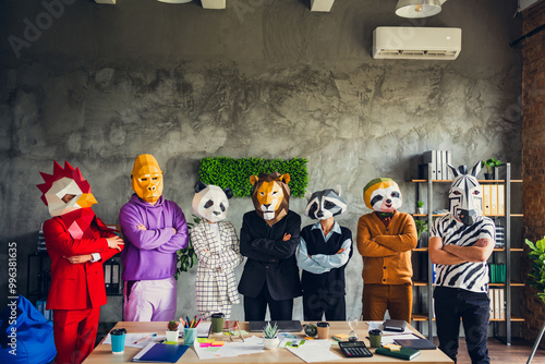 Photo of panda rooster gorilla lion sloth zebra raccoon mask business people crossed arms loft interior office indoors photo