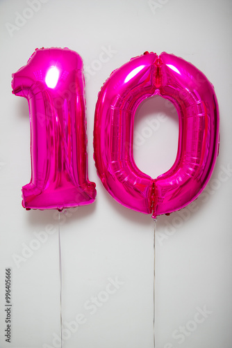 pink number 10 balloons on white background