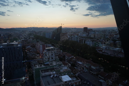 
Tirana city view from luxury sky club bar at night at sunset, view of skyscrapers, pyramid, streets, buildings and trees