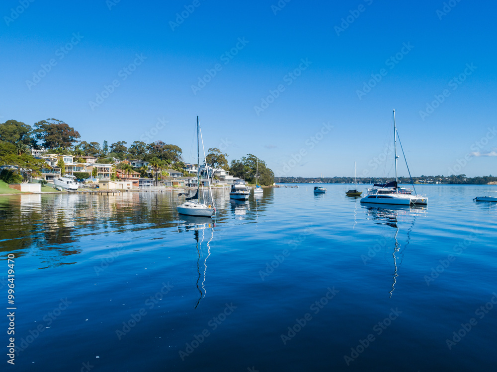 © Austockphoto - Recreational boats moored in water of Lake Macquarie in bright sunlight seen from aerial view © Austockphoto - Recreational boats moored in water of Lake Macquarie in bright sunlight seen from aerial view