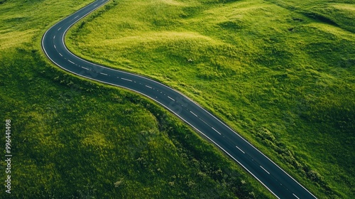 Isolated road cutting through vast grasslands, aerial view with copy space available.