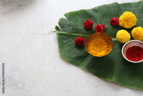Traditional Hindu Pooja Essential items, Bannana leaf,Turmeric, Kumkum, Mari gold flower Isolated on White Background
