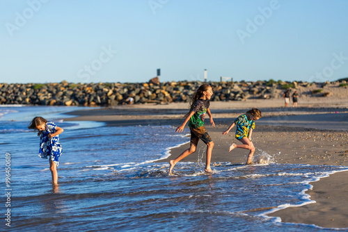 Torres Strait Islander children playing together at beach on windy day