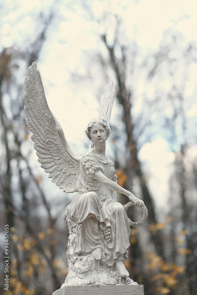 beautiful Angel statue on old cemetery, autumn nature background. Design for condolence, mourning card or obituary. symbol of religion, faith, mourn, memory. all saints day, All Souls Day beautiful Angel statue on old cemetery, autumn nature background. Design for condolence, mourning card or obituary. symbol of religion, faith, mourn, memory. all saints day, All Souls Day
