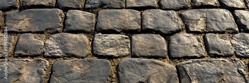 Cobblestone street texture, with uneven stones and weathered surfaces