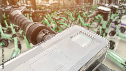 Closeup of Electric Scooter Handlebar with Smartphone Mount, Modern Urban Mobility Solution for Rental Services, Eco-Friendly Commuting, and Sustainable Transportation.