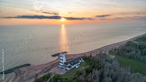 Obraz na plátně West Point lighthouse stands prominently on the coastline as the sun sets over t