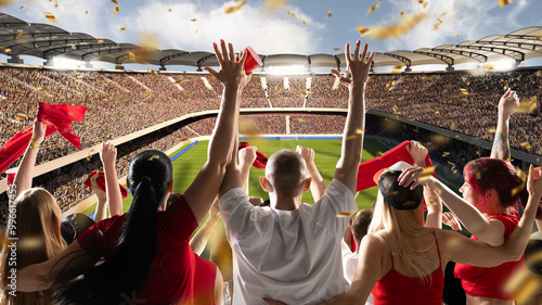 Vibrant soccer stadium scene filled with fans waving red flags and cups, with bright confetti falling around them, as sun shines over field. Concept of sport evens, championship, celebration, victory.