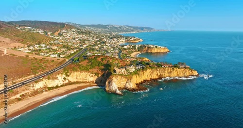 Highly populated area on the rocky coast of the Pacific Ocean. Drone footage approaches the mountainous shore of Los Angeles, California, USA. photo