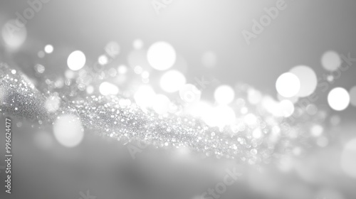 Abstract silver glitter background with bokeh lights.