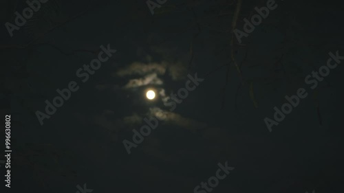 The movement of clouds next to the full moon, beautiful and peaceful