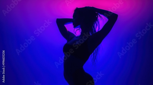 Silhouette of a woman in blue and pink neon light.