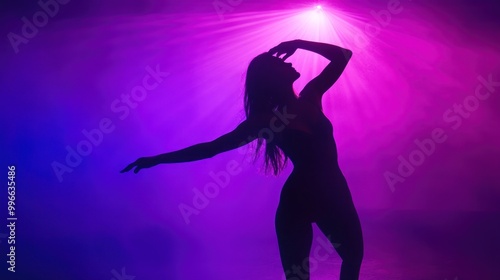 Silhouette of a woman dancing under a spotlight.