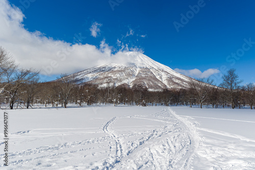 Stratovolcano Mount Yotei covered in fresh snow on a crisp, blue sky day (Hokkaido, Japan) photo