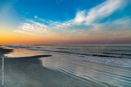 Sunrise over ocean with orange and blue sly photo