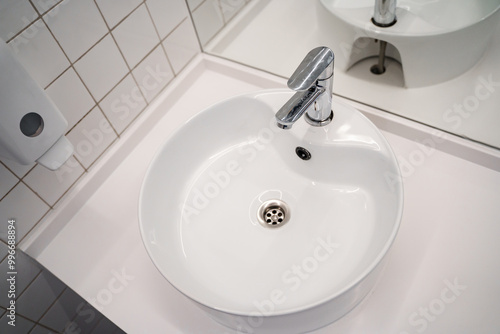 White sink in the public bathroom, modern design. photo