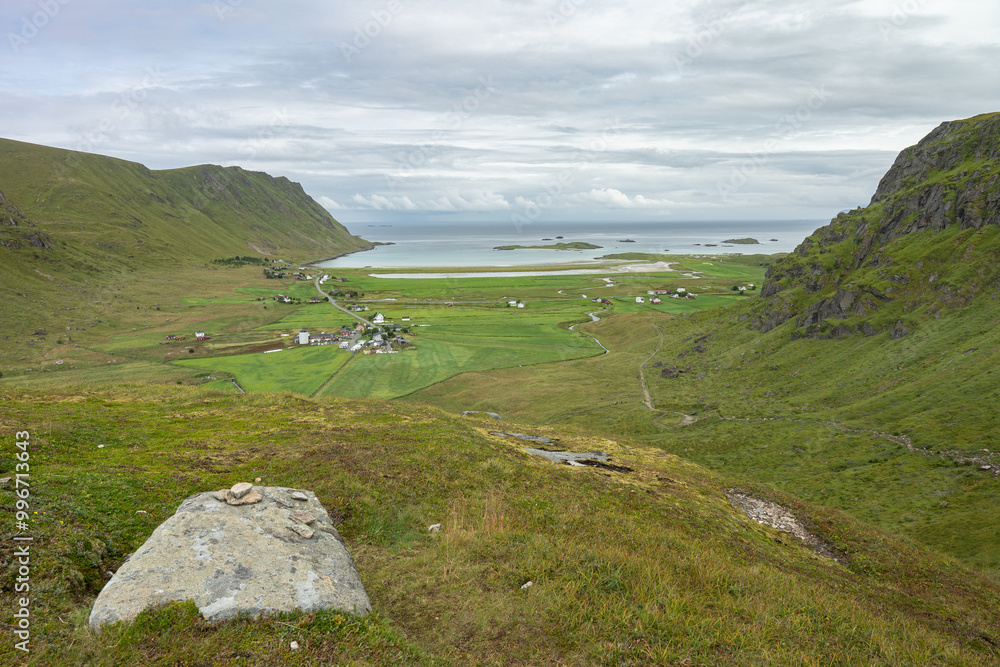 Valley ocean beach surrounded by mountains far view, Lofoten Norway