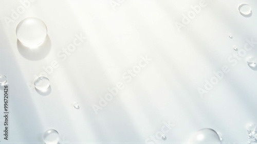 白い背景の上に輝く光を乱反射したクリアな水の雫　Clear water drops with diffused reflection of shining light on a white background